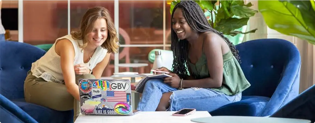 two women looking at a laptop
