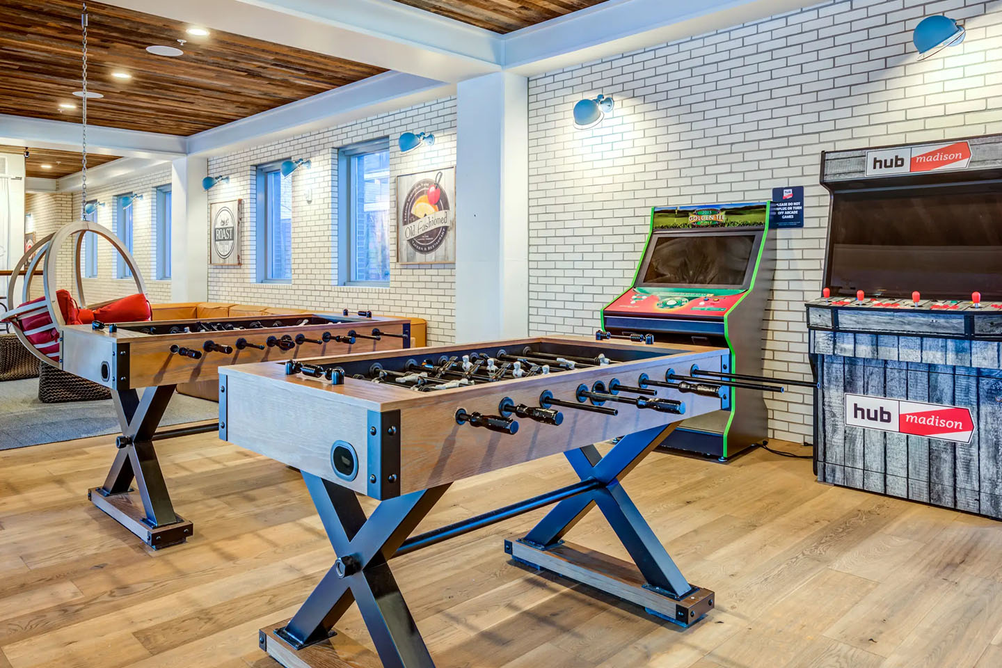 A pool table and a retro arcade machine.